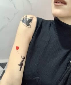 Girl with balloon flash tattoo on skin