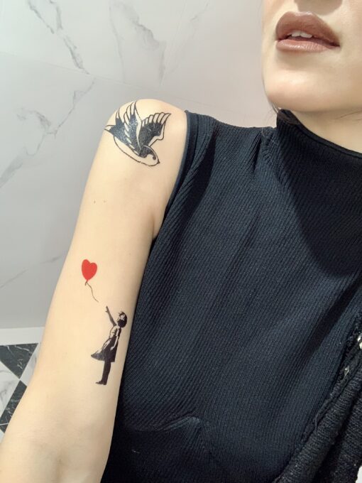 Girl with balloon flash tattoo on skin