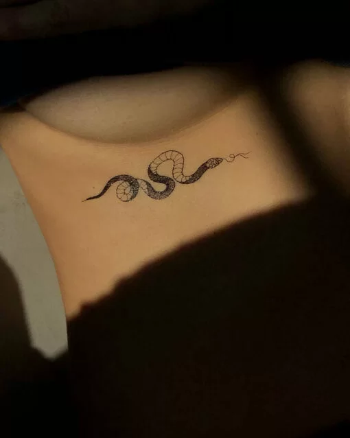 Small snake underboob tattoo